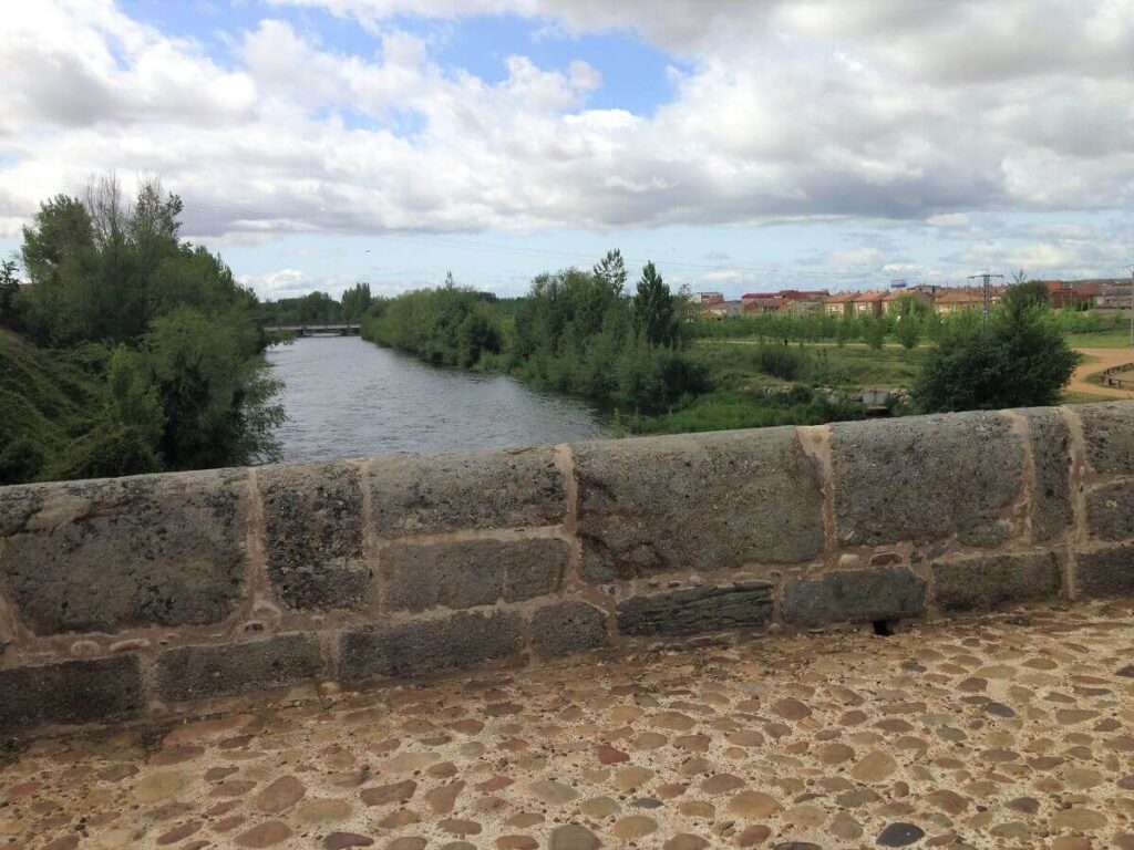 View of a river from an old stone bridge