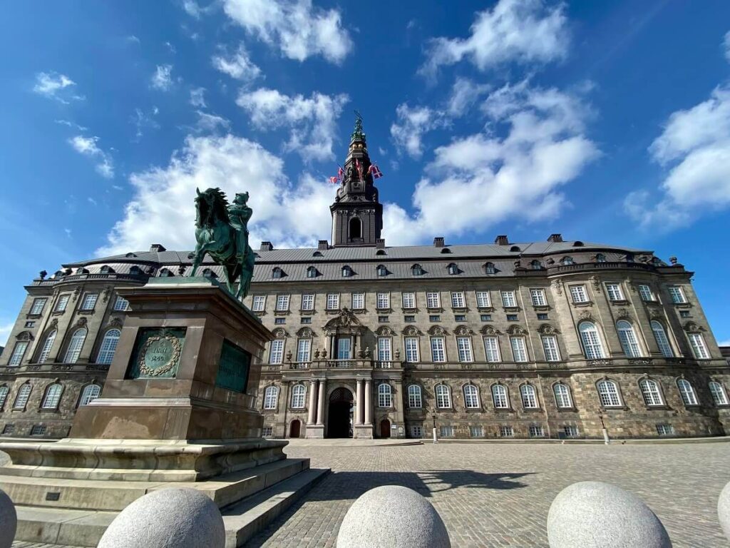Christiansborg seen from behind with an equestrian statue of a Danish king in front