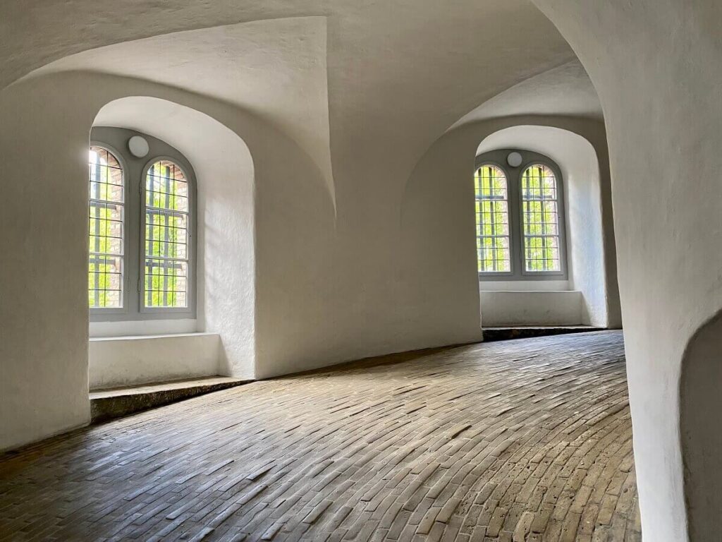 A ramp paved with bricks curves upward inside the Round Tower